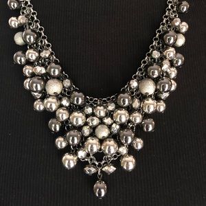 Statement necklace with silver beads.